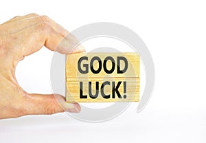 Good luck symbol. Concept words Good luck on beautiful wooden block. Beautiful white table white background. Businessman hand.