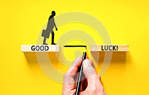 Good luck symbol. Concept words Good luck on beautiful wooden block. Beautiful yellow table yellow background. Businessman hand.