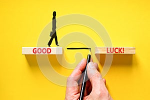 Good luck symbol. Concept words Good luck on beautiful wooden block. Beautiful yellow table yellow background. Businessman hand.