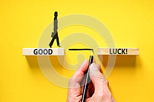 Good luck symbol. Concept words Good luck on beautiful wooden block. Beautiful yellow table yellow background. Businessman hand.