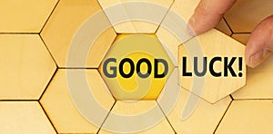 Good luck symbol. Concept words Good luck on beautiful wooden puzzle. Beautiful yellow background. Businessman hand. Business,