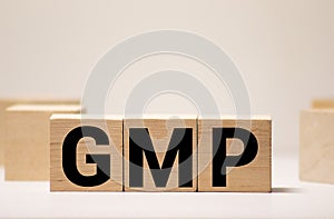 Good Manufacturing Practice. GMP the word on wooden cubes