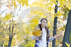 Good mood. autumn kid fashion. inspiration. happy childhood. back to school. girl with maple leaves relax in park. fall