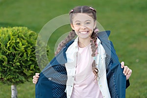 Good mood. Autumn weather. Cypress tree. Happy child with thuja. Positive kid. Little girl with trendy hairstyle. Spring