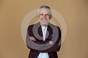 A man with a crossed arms looking contented and smiling photo