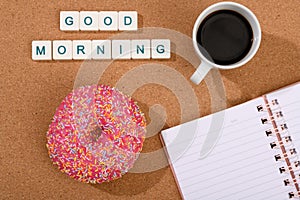 Good morning with coffee, donut and notebook