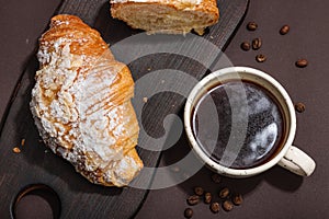 Good morning concept. Breakfast with cup of coffee and fresh croissant. Sweet creamy sauce