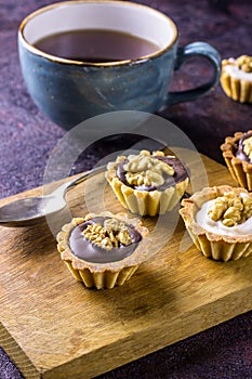 Espresso coffee accompanied by delicious almond biscuits cookies on a dark background photo