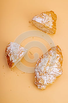 Good morning concept. Fresh croissants with cream filling and almond flakes. Sweet dessert