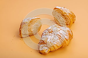 Good morning concept. Fresh croissants with cream filling and almond flakes. Sweet dessert