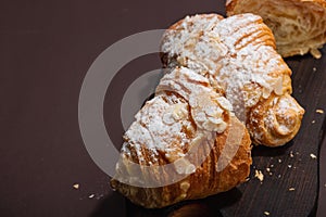 Good morning concept. Fresh croissants with cream filling and almond flakes. Sweet dessert