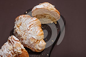 Good morning concept. Fresh croissants with cream filling and almond flakes. Sweet dessert