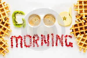 Good morning concept. `Good morning` words laid out with pieces of fruit and pomegranate seeds.