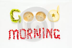 Good morning concept. `Good morning` words laid out with pieces of fruit and pomegranate seeds.