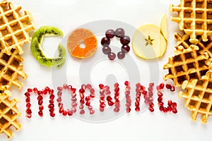 Good morning concept. `Good morning` words laid out with pieces of fruit and pomegranate seeds