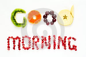 Good morning concept. `Good morning` words laid out with pieces of fruit and pomegranate seeds