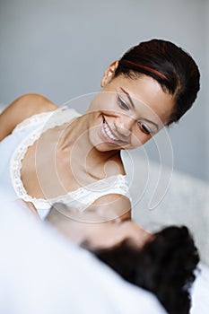 Good morning. Cute woman lying alongside her boyfriend in bed.