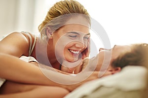 Good morning, handsome. an affectionate young couple relaxing in bed at home.