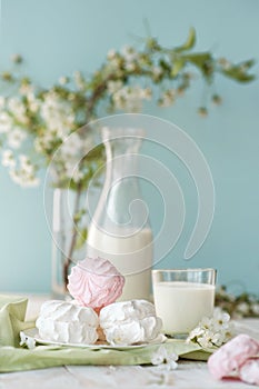 Good morning! Russian marshmallow or zephyr with bottle and glass of milk on tree background. Spring composition.