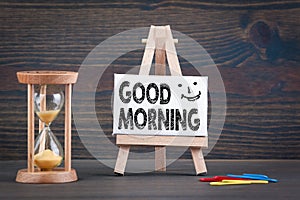 Good morning. Sandglass, hourglass or egg timer on wooden table