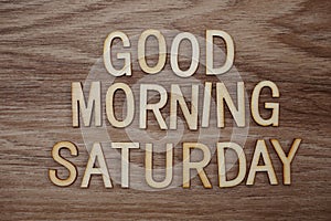 Good Morning Saturday text message on wooden background