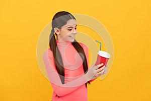 good morning. teen girl drinking tea. portrait of enjoyment. happy child hold plastic cup