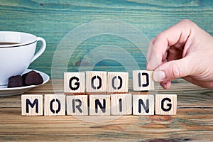 Good morning. Wooden letters on the office desk, informative and communication background