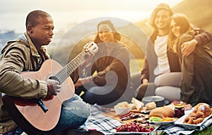 Good music and good company. Shot of a group of young friends having fun at a picnic.