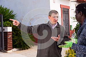 Good neighbors talking in the backyard of the house