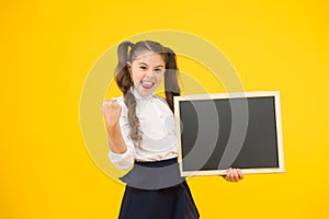 Good news. Announcement and promotion. Check this out. Girl school uniform hold blackboard. Back to school. Schoolgirl