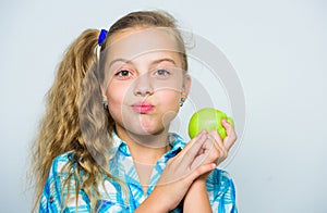 Good nutrition is essential to good health. Kid girl eat green apple fruit. Nutritional content of apple. Vitamin