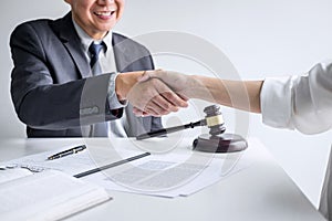 Good service cooperation of Consultation between a male lawyer and business woman customer, Handshake after good deal agreement,