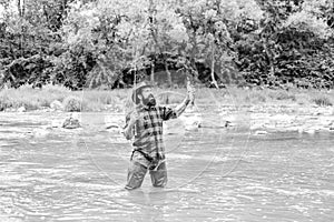 Good things for Good Moments. hobby and sport activity. bearded fisher in water. fisherman show fishing technique use