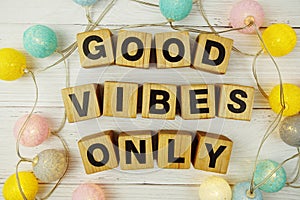 Good Vibes Only alphabet letters with LED cotton balls decoration on wooden background