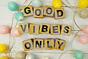 Good Vibes Only alphabet letters with LED cotton balls decoration on wooden background