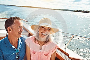 Good vibes out on the ocean. a mature couple enjoying a relaxing boat ride.