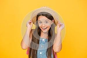 Good vibes. Portrait of happy cheerful girl in summer hat yellow background. Beach style for kids. Little beauty in