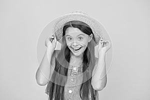 Good vibes. Portrait of happy cheerful girl in summer hat yellow background. Beach style for kids. Little beauty in