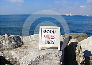 Good Vibes only symbol. Concept words Good Vibes only on chalk blackboard. Beautiful sea background. Business and Good Vibes only