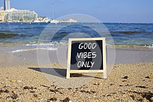 Good Vibes only symbol. Concept words Good Vibes only on chalk blackboard. Beautiful sea background. Business and Good Vibes only