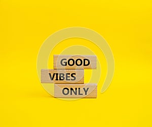 Good Vibes only symbol. Concept words Good Vibes only on wooden blocks. Beautiful yellow background. Business and Good Vibes only