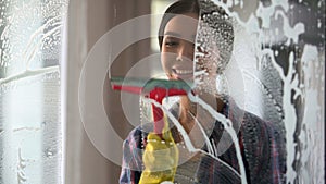 Good wife with pleasure cleaning house and washing room windows, order at home