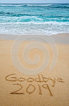 Goodbye 2019 written in the sand- New Yearâ€™s concept