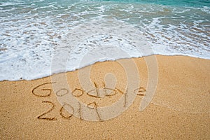 Goodbye 2019 written in the sand- New Yearâ€™s concept