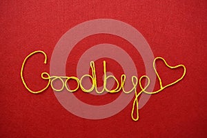 Goodbye ribbon greeting and hearts on red background