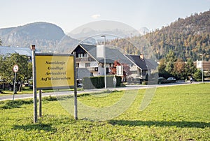 Goodbye sign in different languages with mountains and houses