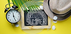 Goodbye Summer Text. Alarm Clock Fedora Hat, Palm Leaf, Sea Shells and Blackboard Room for Text. Flat Lay Traveling Holiday