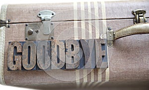 Goodbye word on vintage suitcase