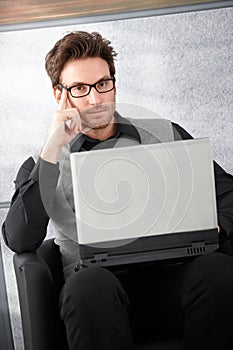 Goodlooking businessman with laptop