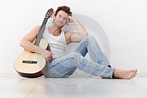 Goodlooking man with guitar smiling